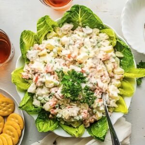 Chicken potato salad served on a bed of lettuce.