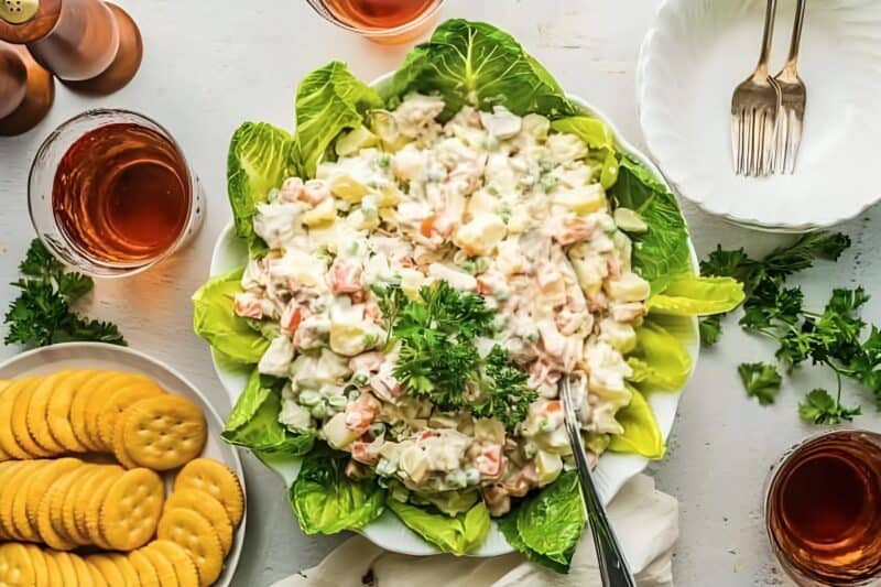 Chicken potato salad served on a bed of lettuce.