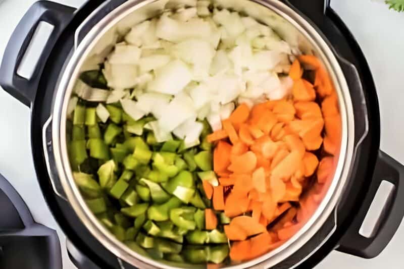 Chopped veggies added to an Instant Pot.
