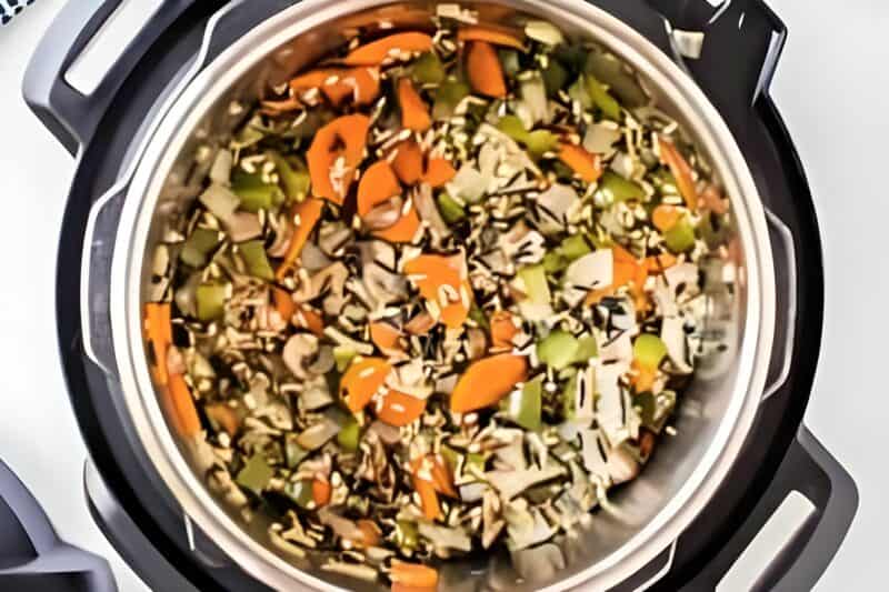 Rice and veggies added to an Instant Pot.