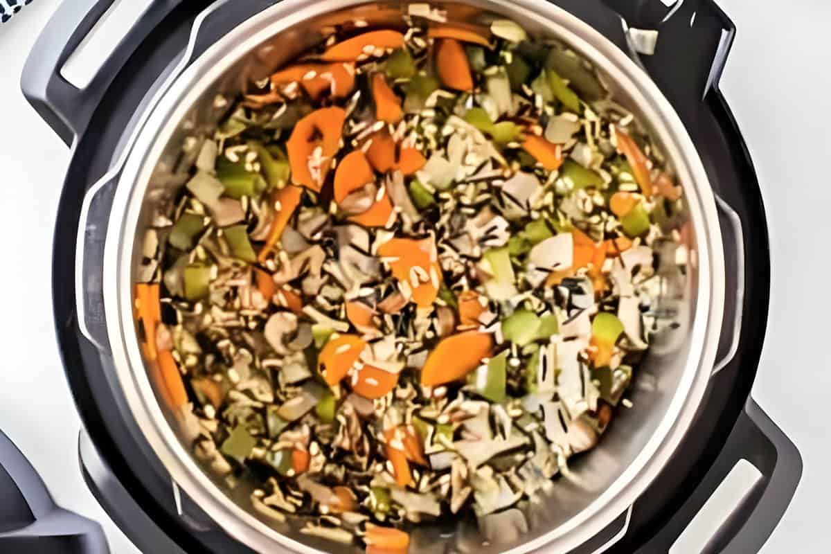 Rice and veggies added to an Instant Pot.
