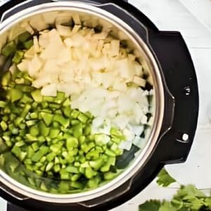 Chopped pepper and onion in an Instant Pot.