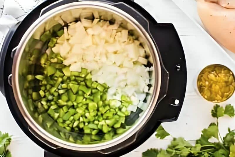 Chopped pepper and onion in an Instant Pot.
