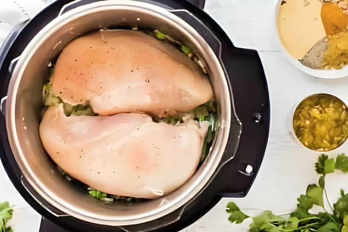 Raw chicken breasts placed in an Instant Pot.