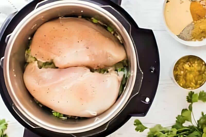 Raw chicken breasts placed in an Instant Pot.