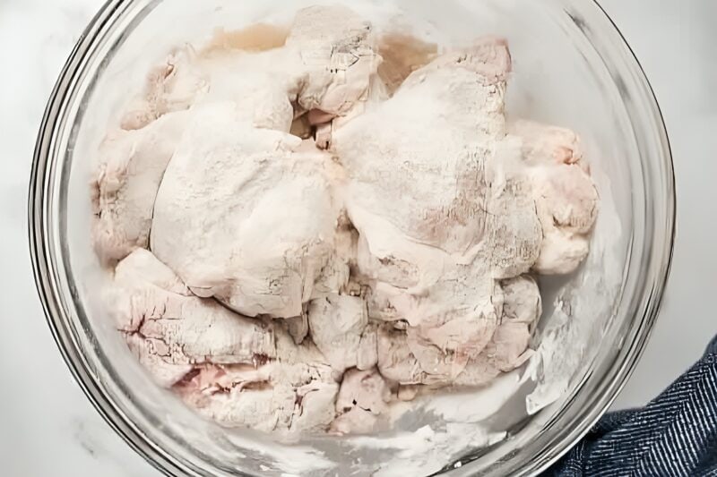Chicken thighs coated in flour.