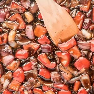 Peppers and onions cooking in a teriyaki sauce.