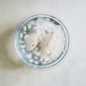cooling poached chicken breasts in an ice bath.