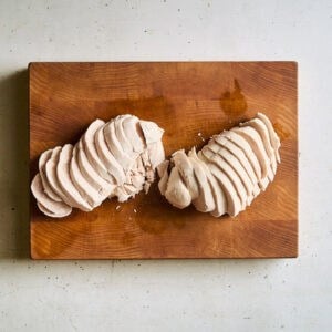 sliced chicken breasts on a cutting board.