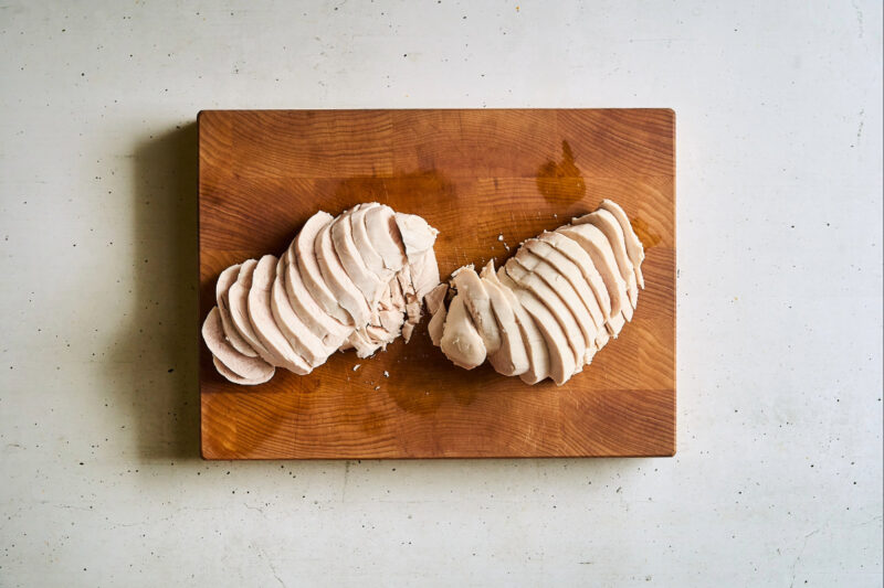 sliced chicken breasts on a cutting board.