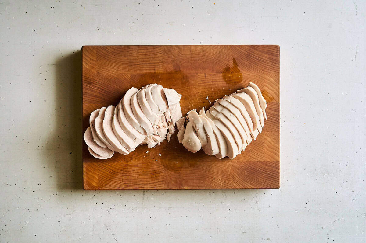 sliced chicken breasts on a cutting board.
