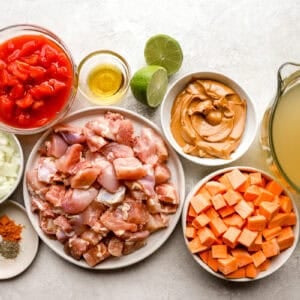 portioned ingredients for peanut chicken soup in individual containers.