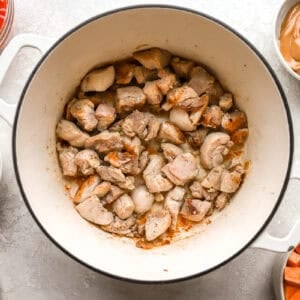 sautéeing diced chicken thighs in a dutch oven.