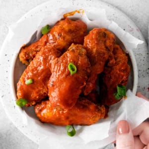 closeup overhead view of air fryer nashville hot wings in a bowl.