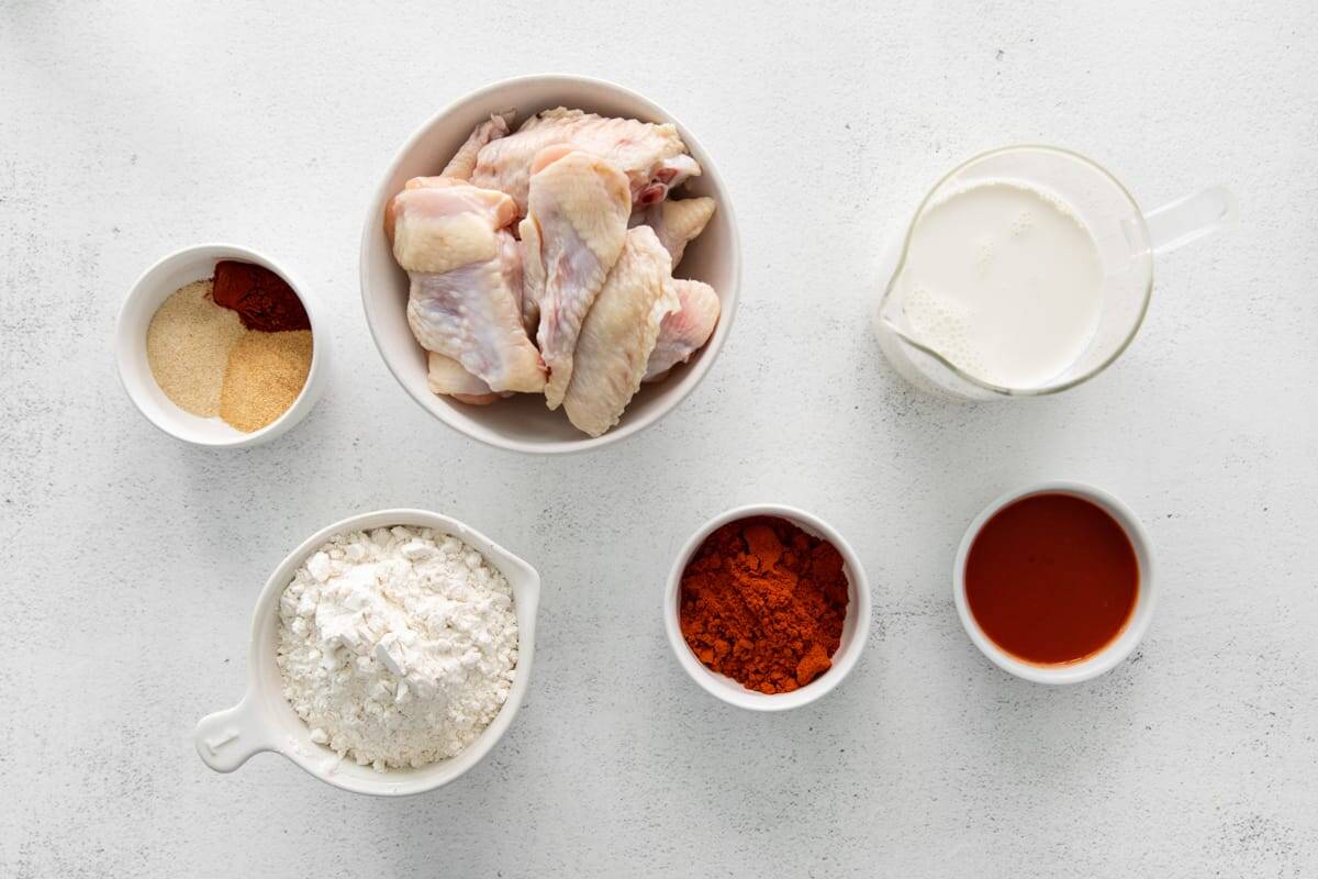 portioned ingredients for air fryer nashville hot wings in individual containers.