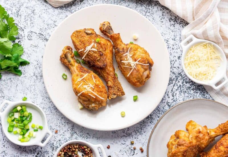 air fryer garlic parmesan chicken drumsticks on white plate