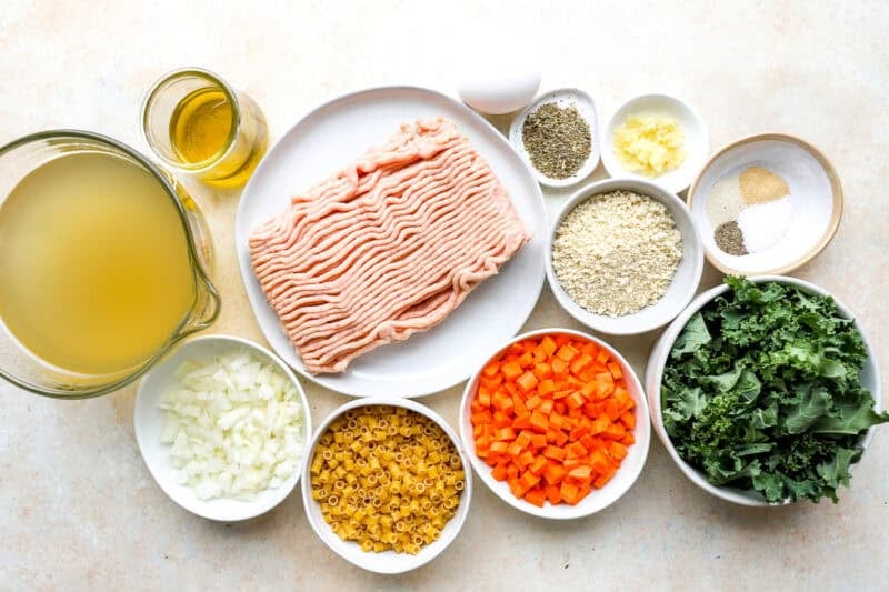 portioned ingredients for chicken meatball soup in individual containers.