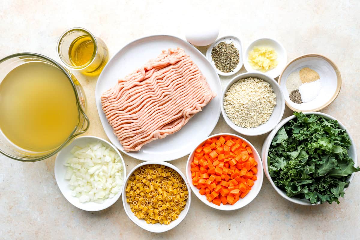 portioned ingredients for chicken meatball soup in individual containers.