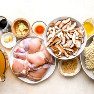 overhead view of portioned ingredients for chicken ramen in individual containers.