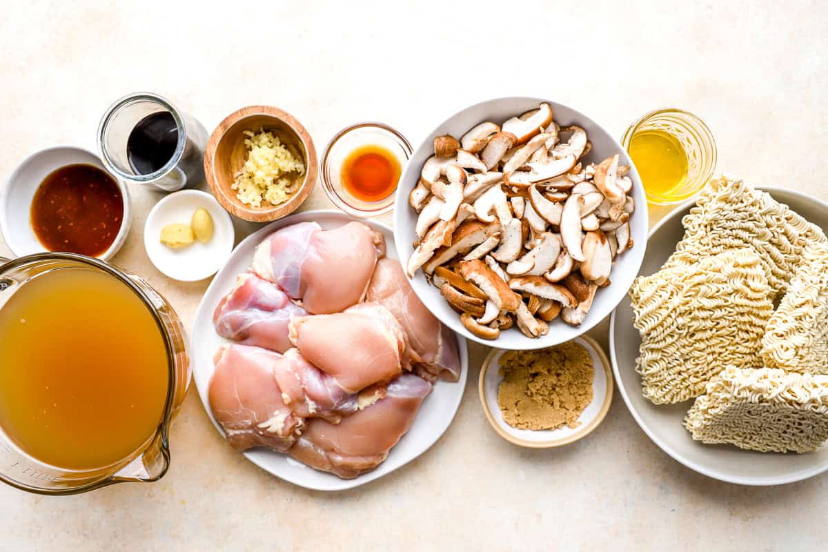 overhead view of portioned ingredients for chicken ramen in individual containers.