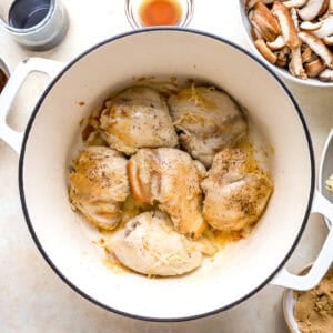 searing chicken thighs in a dutch oven.