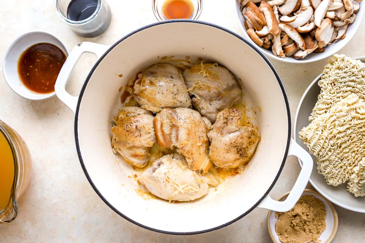searing chicken thighs in a dutch oven.