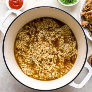 cooking instant ramen noodles in shoyu broth.