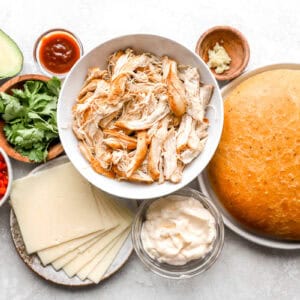 portioned ingredients for a chipotle chicken avocado melt in individual containers.