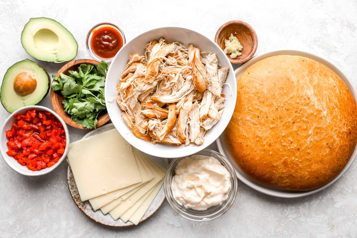portioned ingredients for a chipotle chicken avocado melt in individual containers.