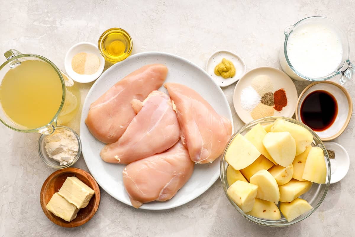 portioned ingredients for creamy chicken and mashed potatoes in individual containers.