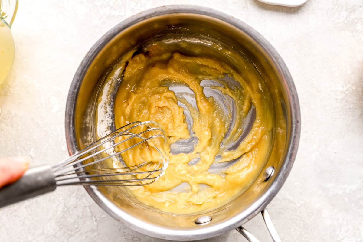 making a flour roux in a saucepan with a whisk.
