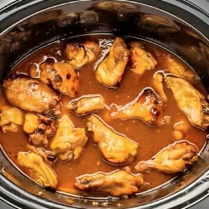cooked chicken wings in bourbon sauce in a crockpot.