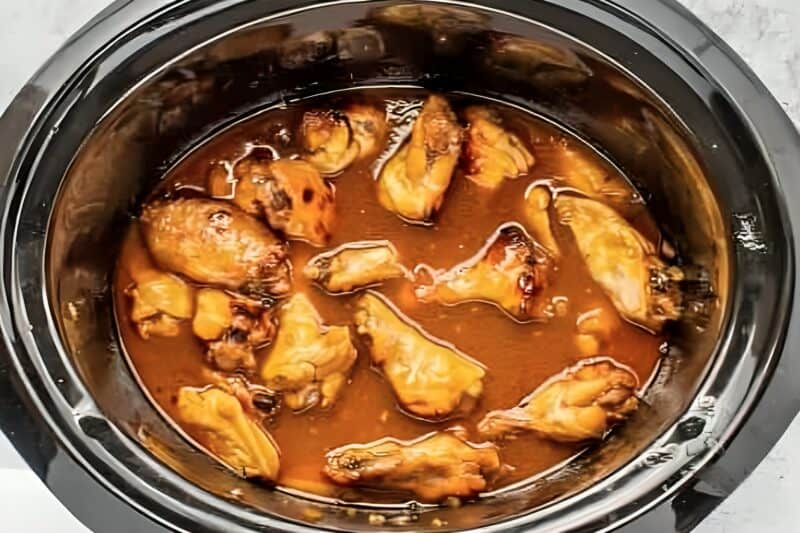 cooked chicken wings in bourbon sauce in a crockpot.