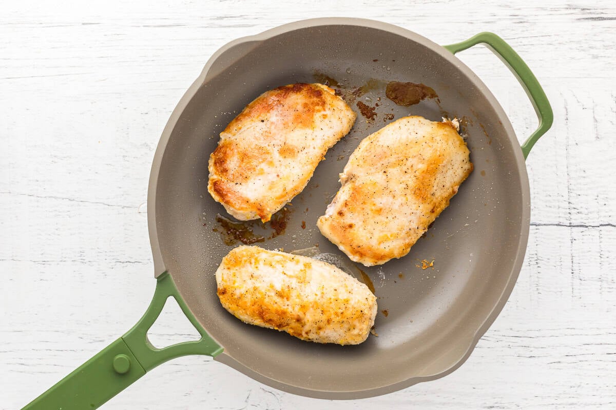 seared chicken breasts in a pan.