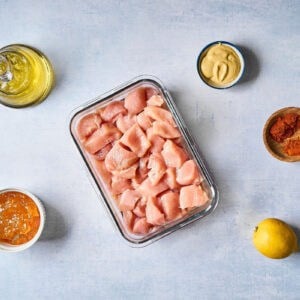 portioned ingredients for apricot chicken skewers in individual containers.