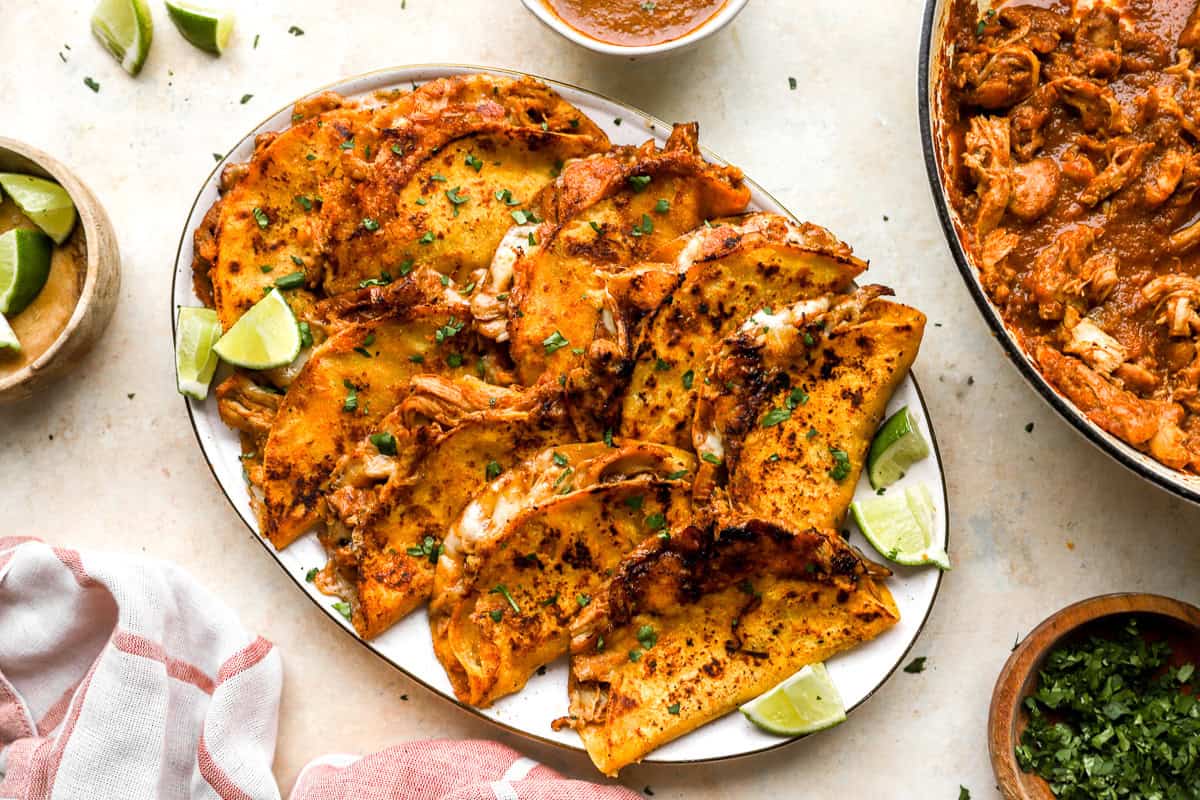 Chicken quesabirria tacos on a serving platter.