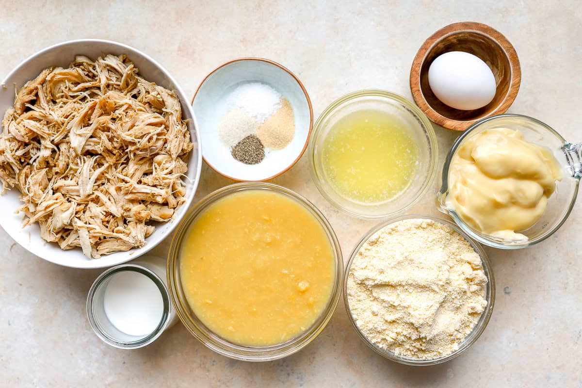 portioned ingredients for chicken cornbread casserole in individual containers.