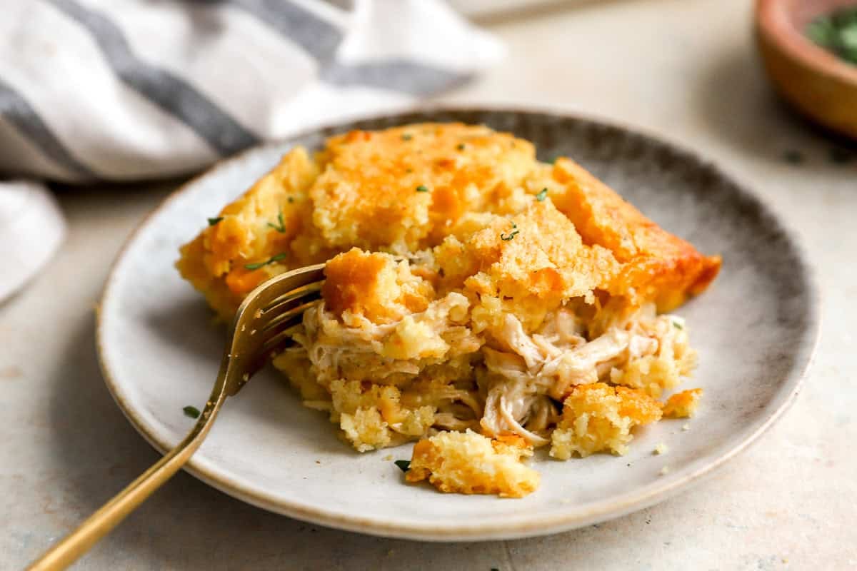 a serving of chicken corn mix casserole on a plate with a fork.