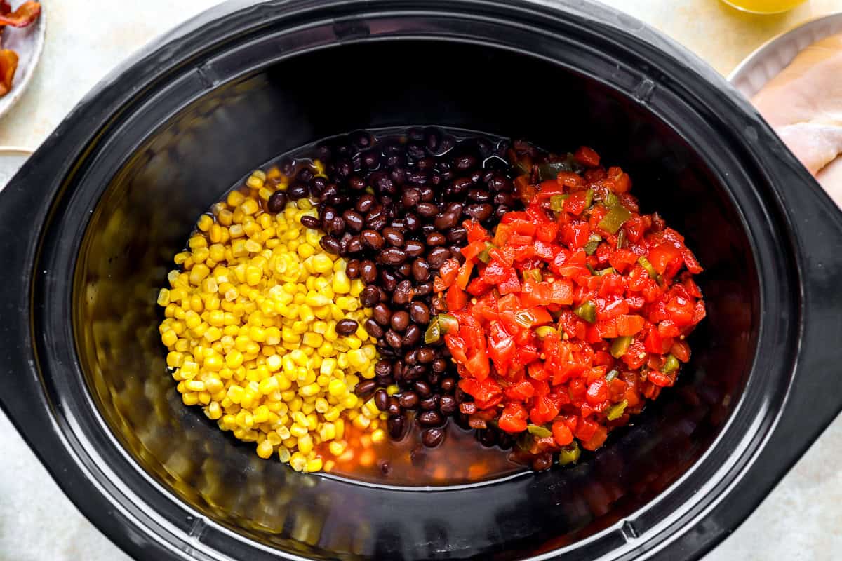 corn, black beans, and diced tomatoes with green chiles in a crockpot.
