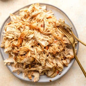 shredded chicken on a plate with two forks.
