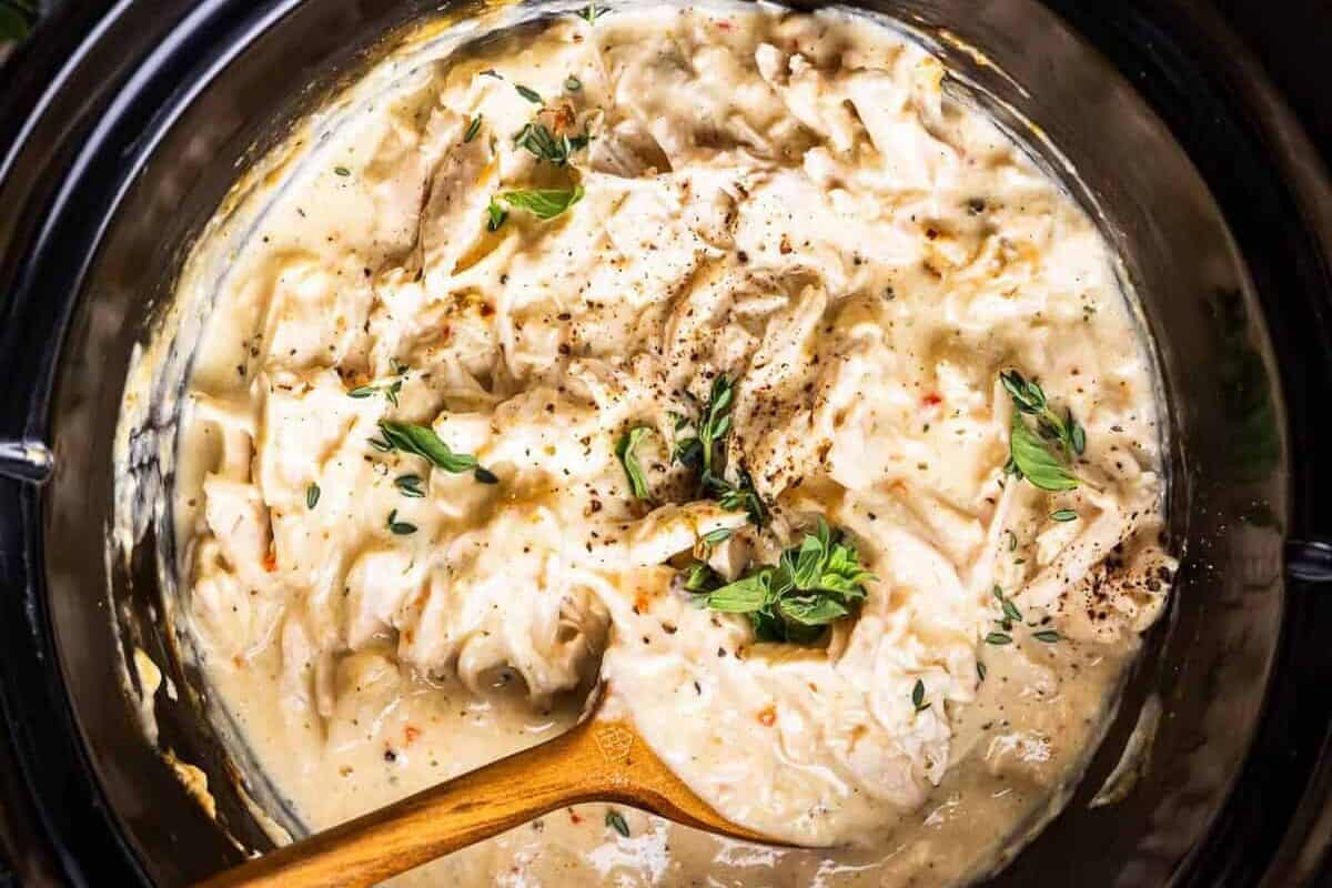 Overhead view of creamy Italian chicken in a Crock Pot.