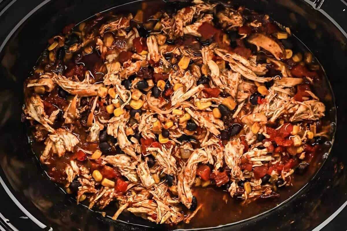 Shredded Mexican taco chicken in a Crockpot.