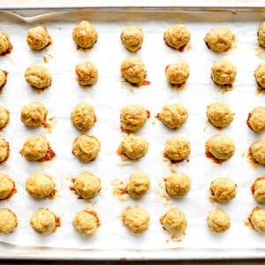 baked chicken meatballs on a baking sheet.