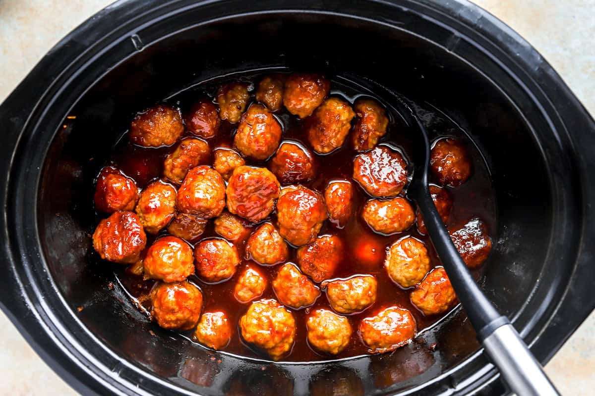 cooked grape jelly chicken meatballs in a crockpot.