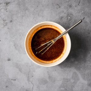 hoisin glaze in a small bowl with a mini whisk.