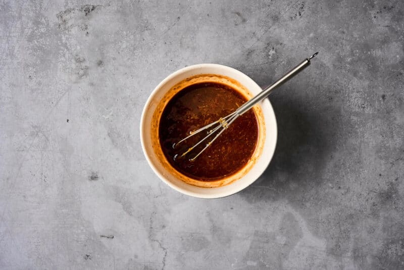 hoisin glaze in a small bowl with a mini whisk.