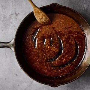 hoisin glazed thickened in a cast iron pan.