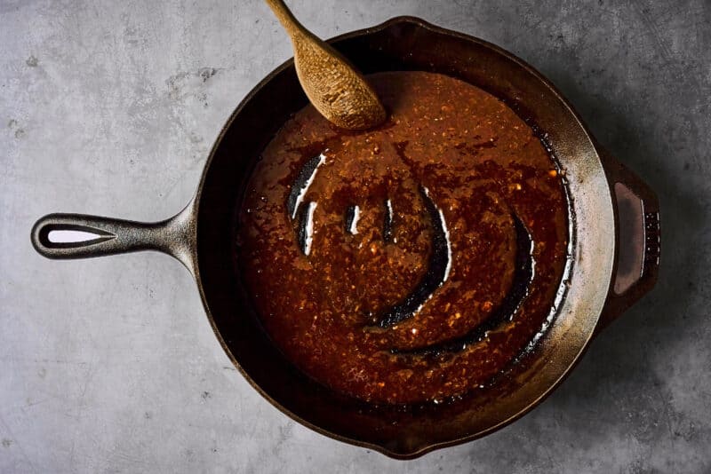 hoisin glazed thickened in a cast iron pan.
