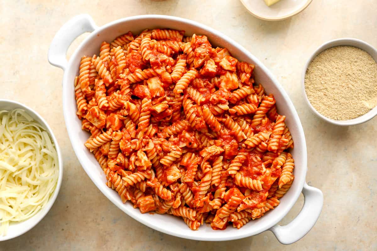 chicken, pasta, and marinara sauce in a casserole dish.
