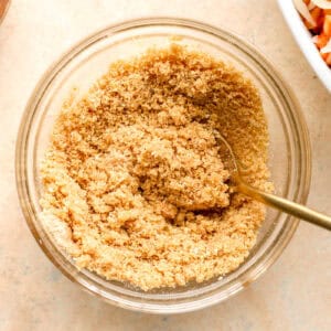 stirred breadcrumbs and melted butter in a small glass dish with a spoon.